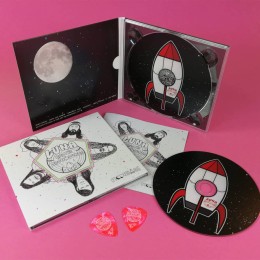 Pink guitar picks and CD digipaks with a booklet for Luna and the Moonhounds