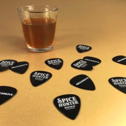 Black guitar picks with full colour printing, produced for Spice Hunter rum